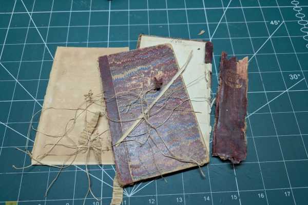 Old book cover, thread, linen sewing tape, and spine.