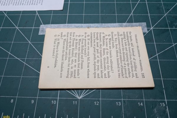 Applying the Kozo paper to the outermost page in the signature.