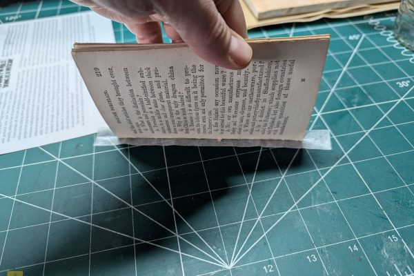 Flipping over the signature to glue to the spine and other side of the signature without stretching the Kozo paper.