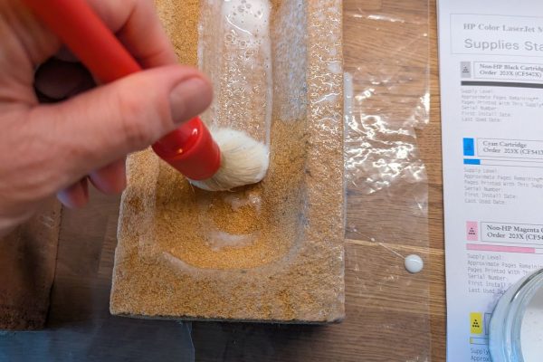 Brushing on the glue to cover the brick.