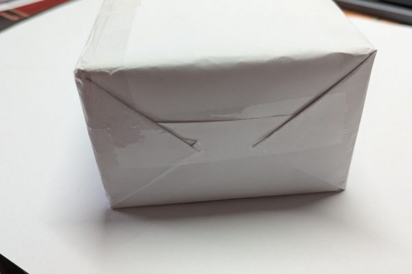Wrapped brick in plain paper.