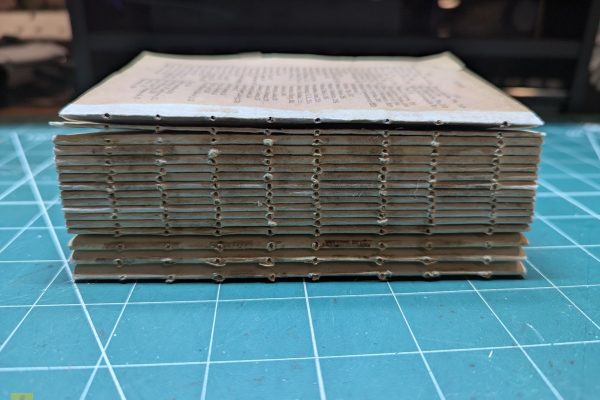 Punching holes in the signatures using my template.