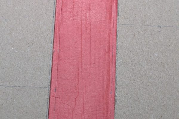 Gluing the cloth to the front and back cover boards.