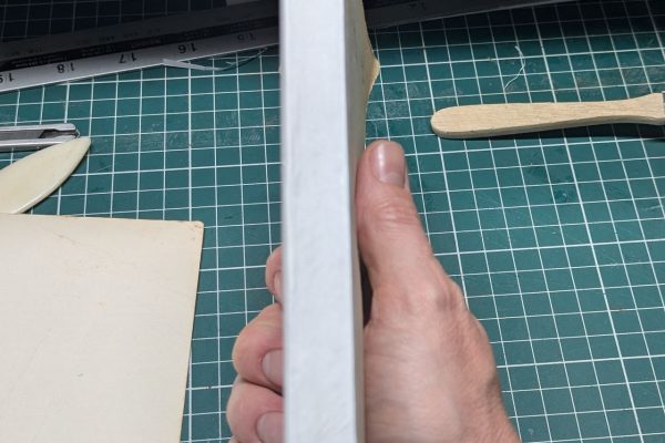 Adding backing paper to the spine.
