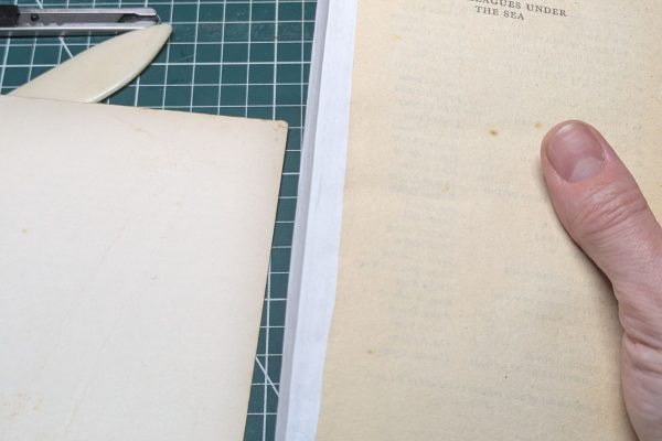 Adding backing paper to the spine.