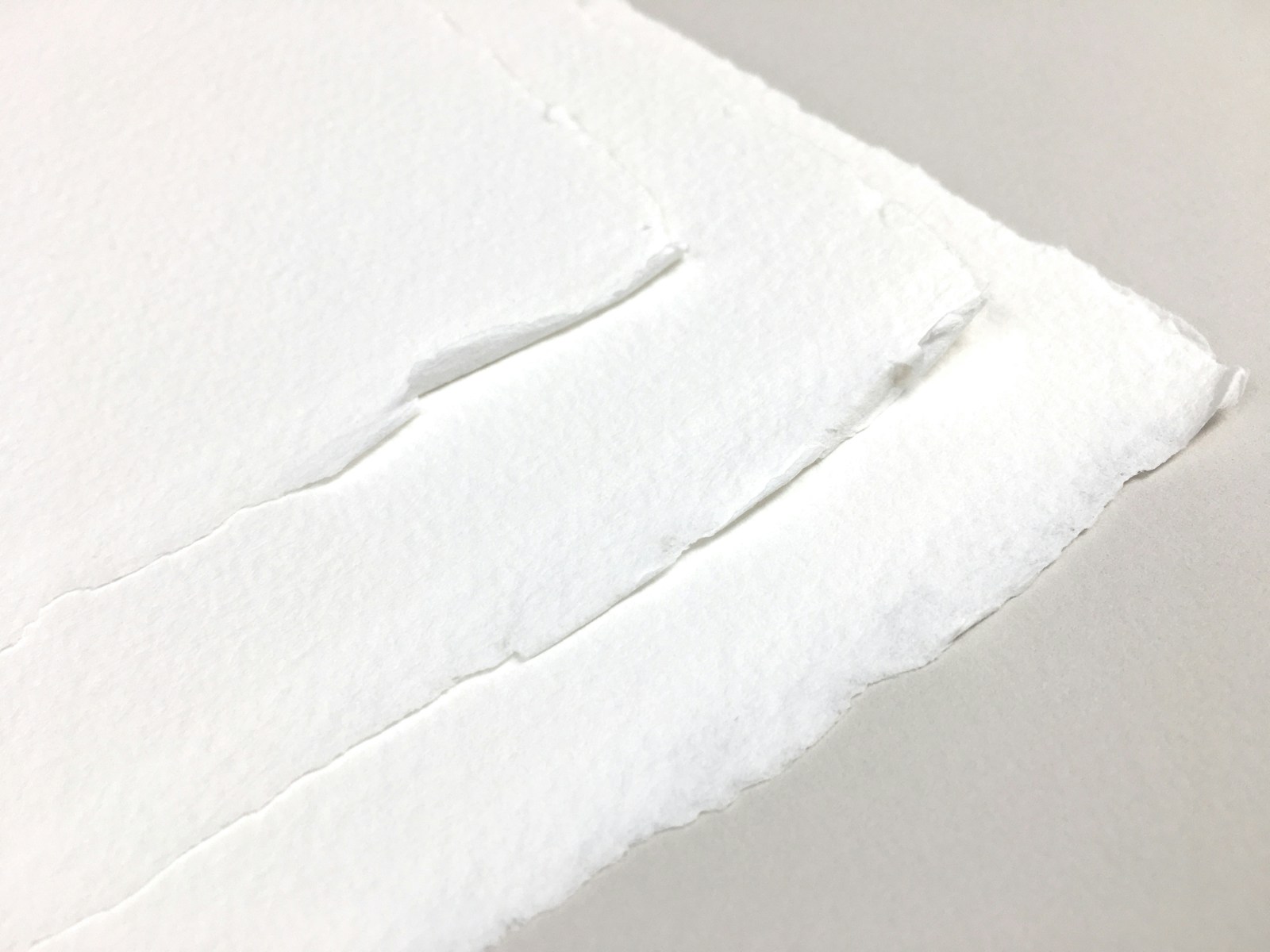 a piece of white paper with a hole in it
