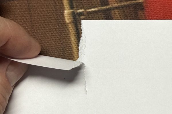 Tearing paper against the grain.