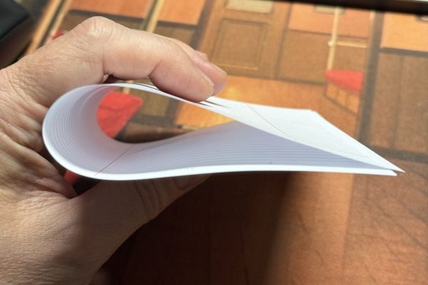 Folding paper along the grain direction.