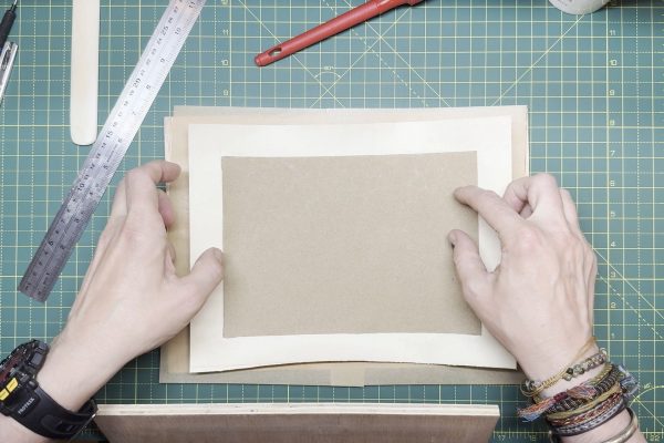 Laying the cover between a layer of grease paper to absorb moisture.