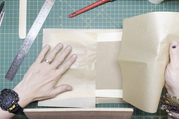 Laying the cover between a layer of grease paper to absorb moisture.