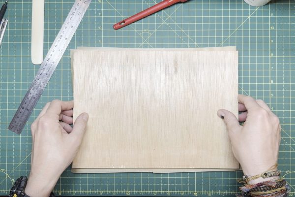 Placing the top board over the cover.