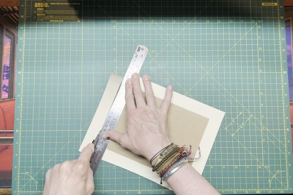Trimming the edges to the card.