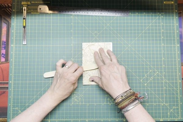 Using a bone folder.