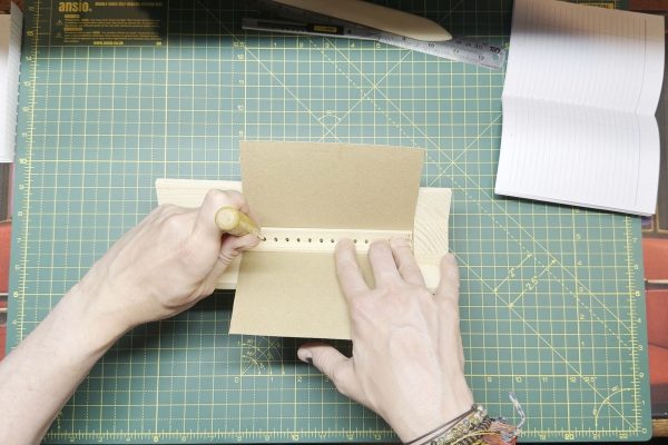 Using a punching cradle.
