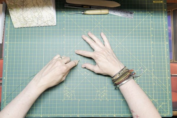 Push the needle through the flattened part.