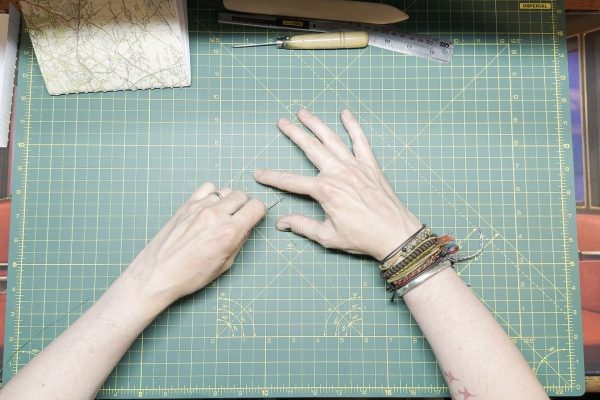 Push the needle through the flattened part.