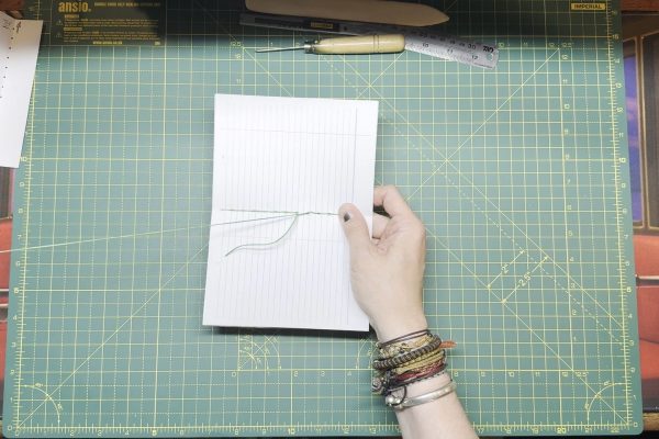 Stop sewing when you are at the seventh hole from the top, one above where you started.
